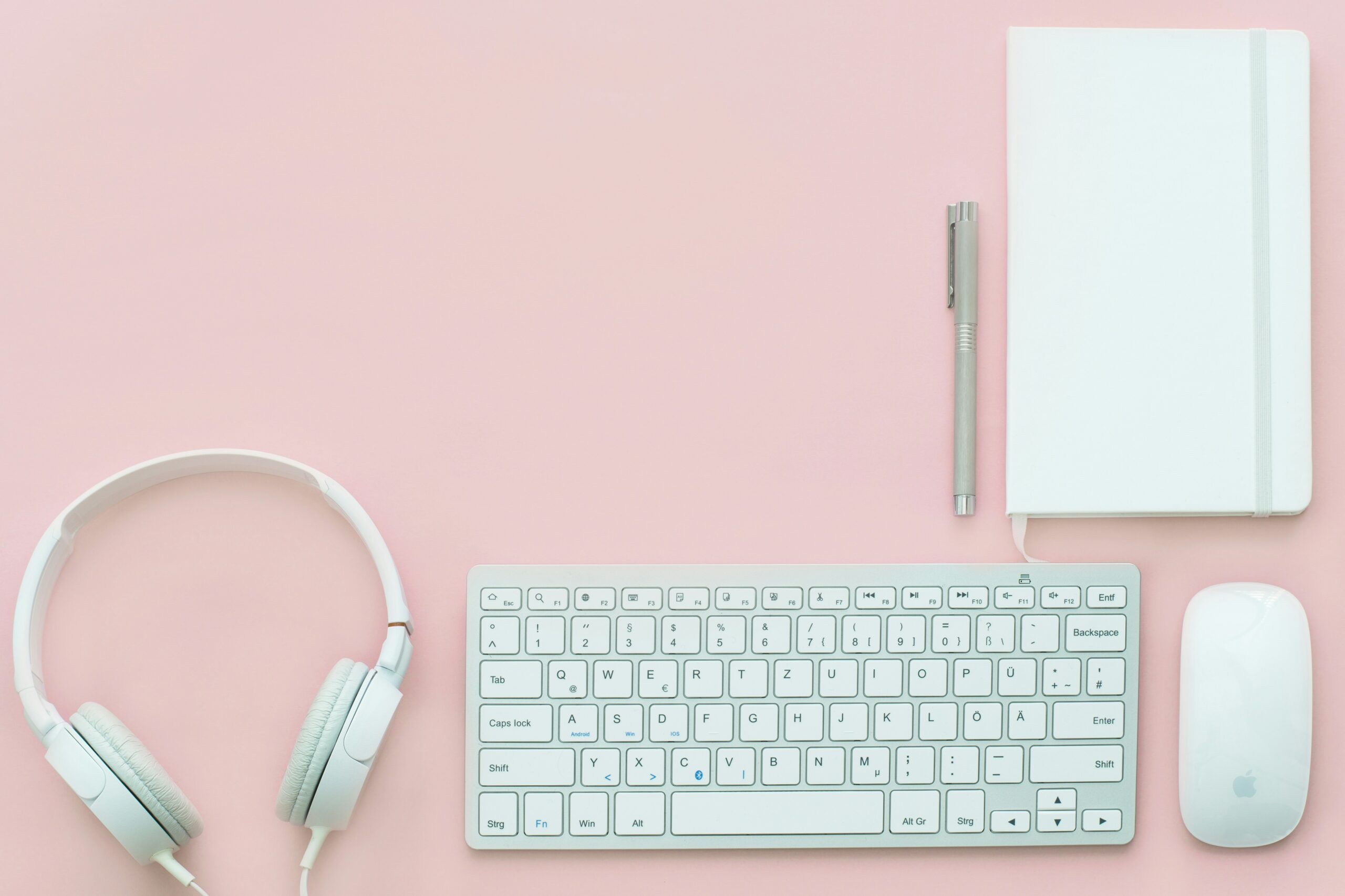 White keyboard on pink background