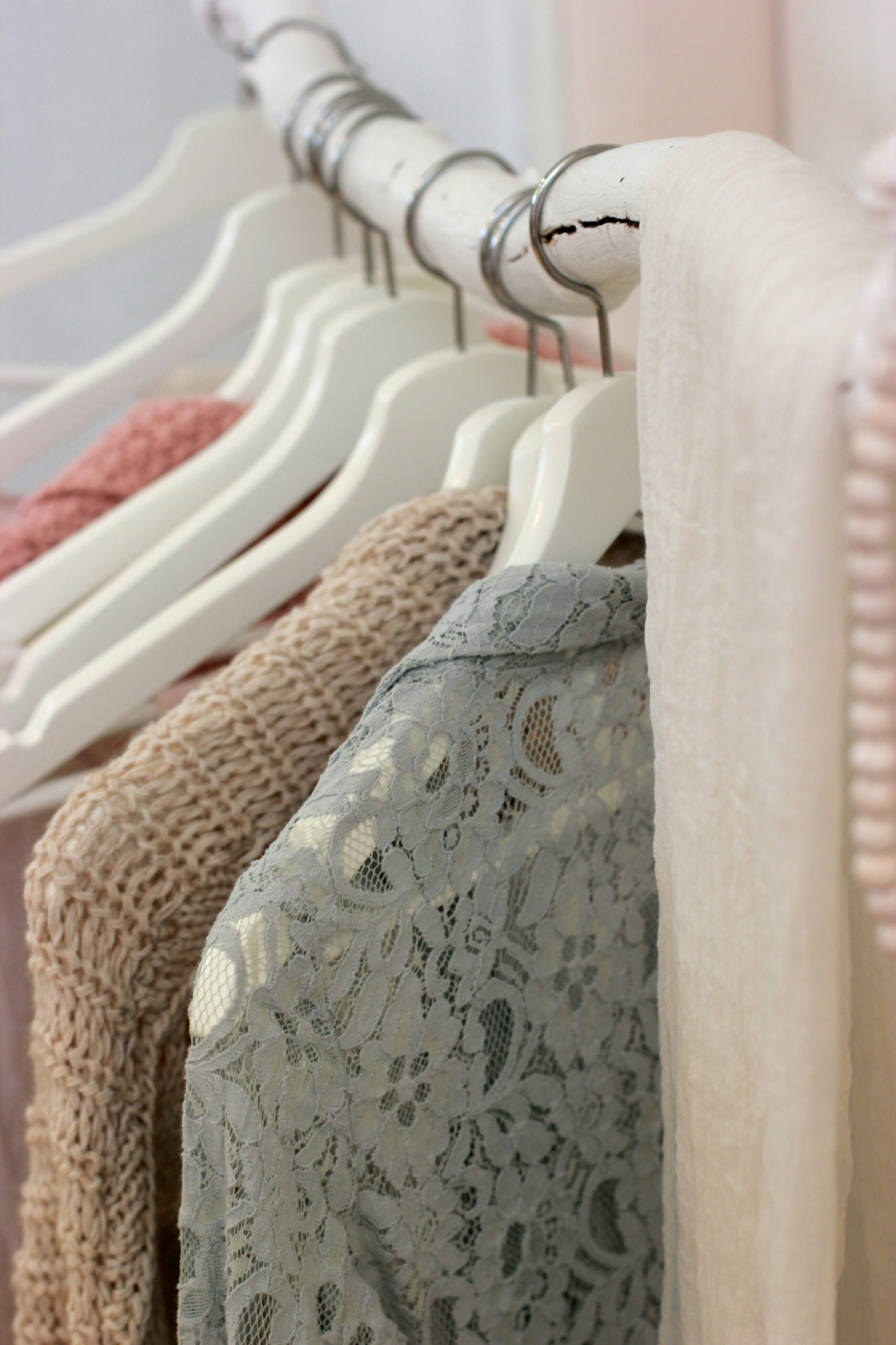 Clothes hanging ona whote rack.