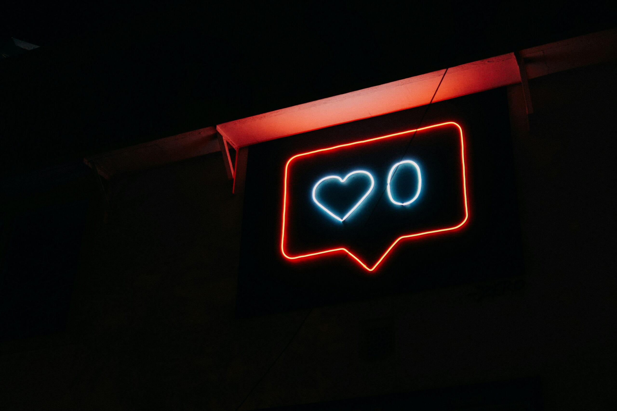 a neon sign with a heart and the number 0