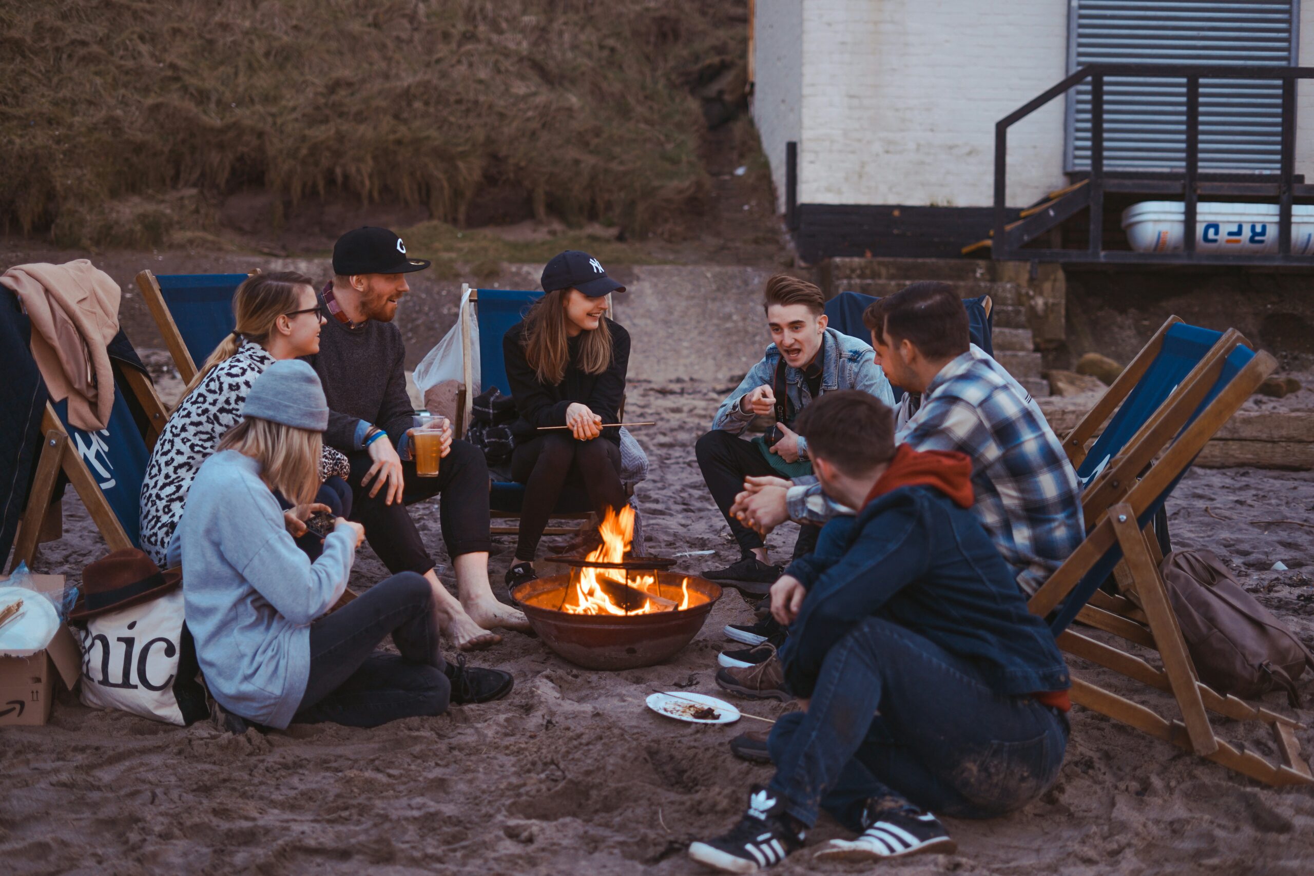 Since I believe cohesion is the best trait of textuality, this image represents that idea. This image shows a group of friends outside (evening) and close together near a campfire having a deep conversation, building connections.