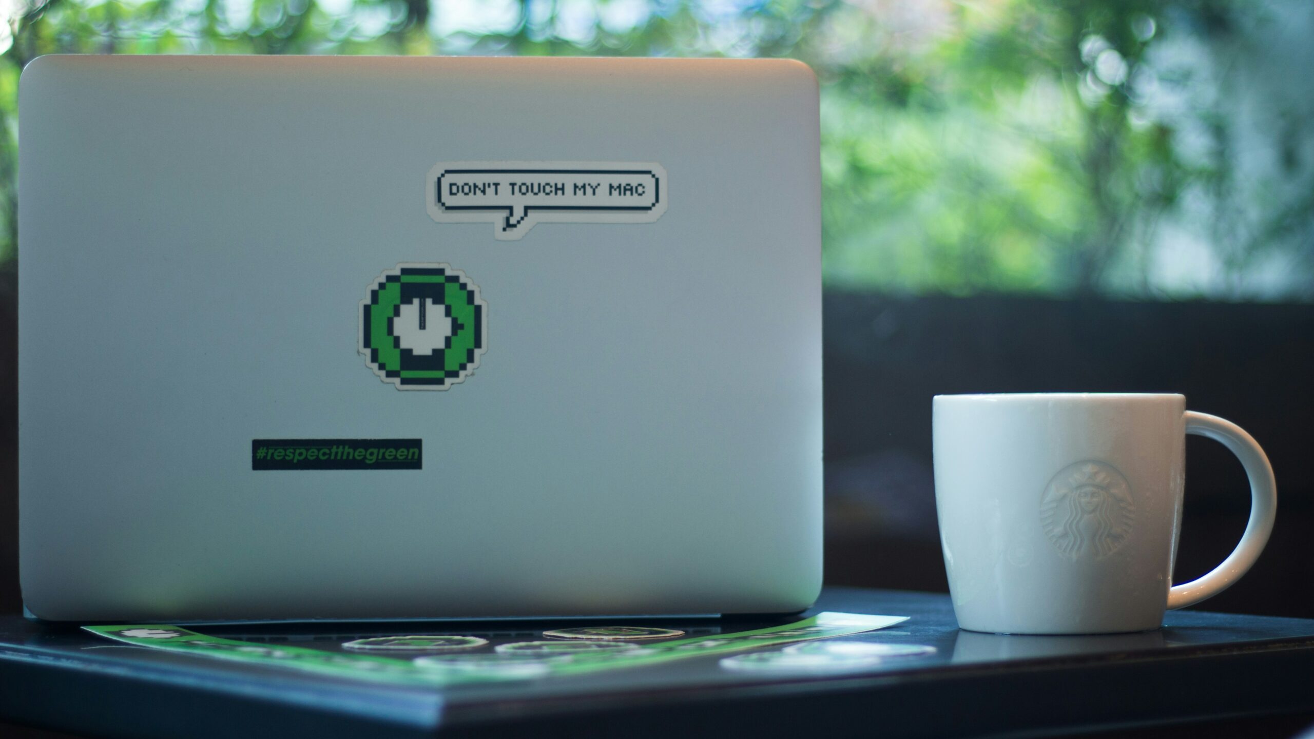 macbook with sticker saying don't touch my mac