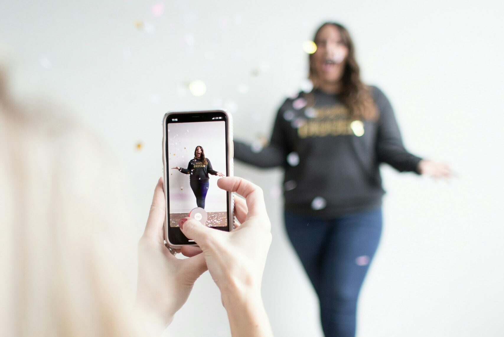 Digital rhetoric: Blonde woman in foreground is recording a Tiktok video of a brunette woman in the background.