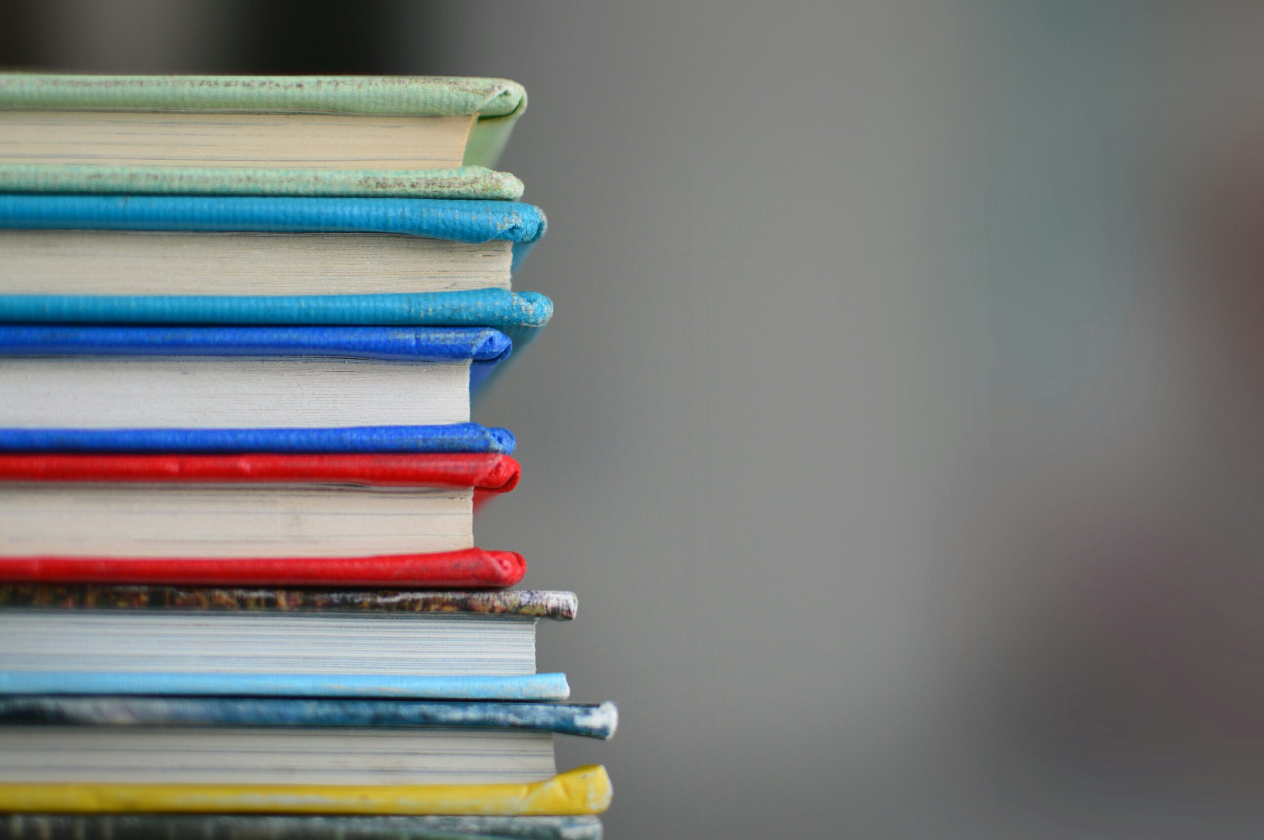 A stack of books in a print form of media.