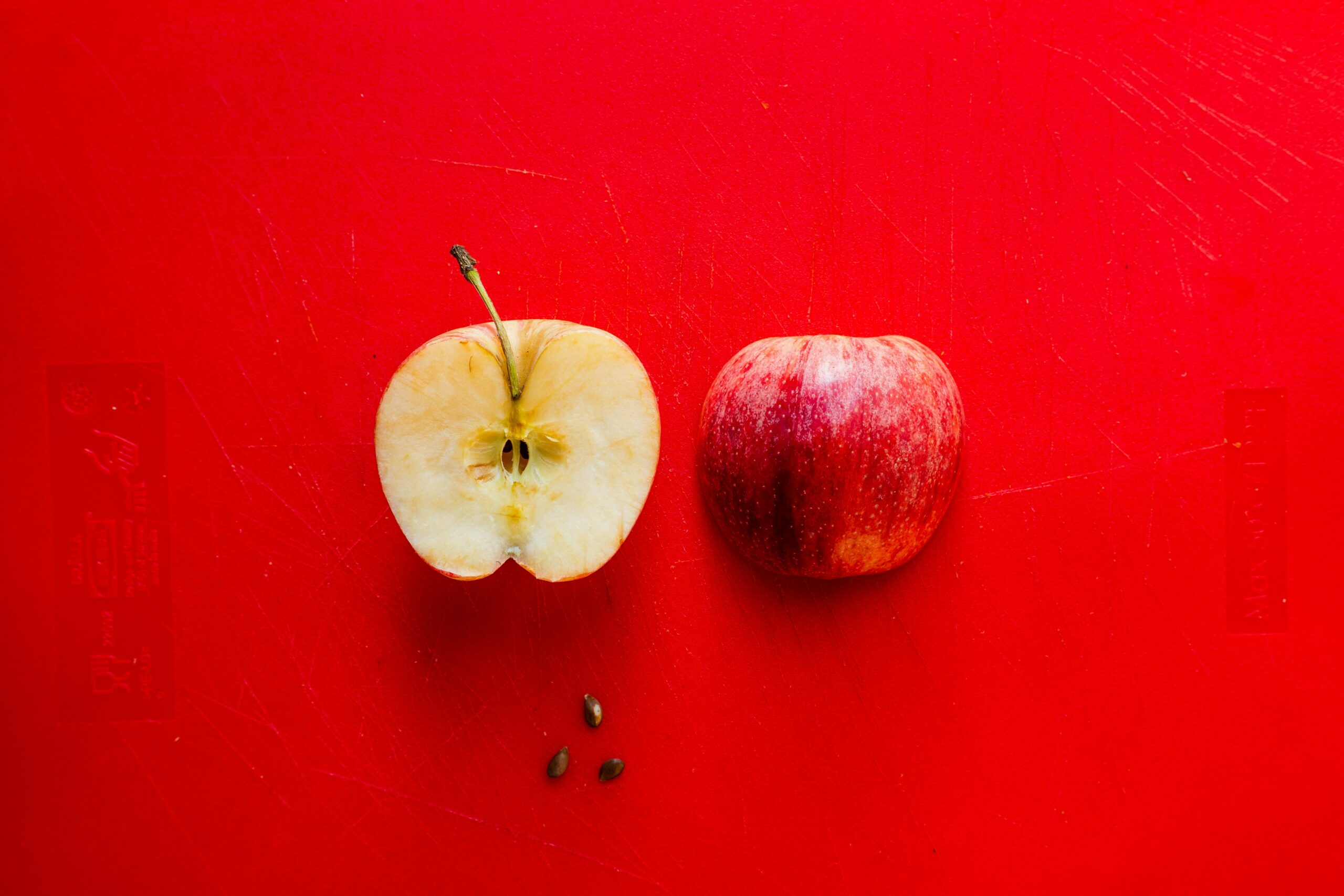 The two halves of an apple were laid together against a red background. One half shows only its core, and the other its skin. Now replace the halves with visual rhetoric and the study of design.