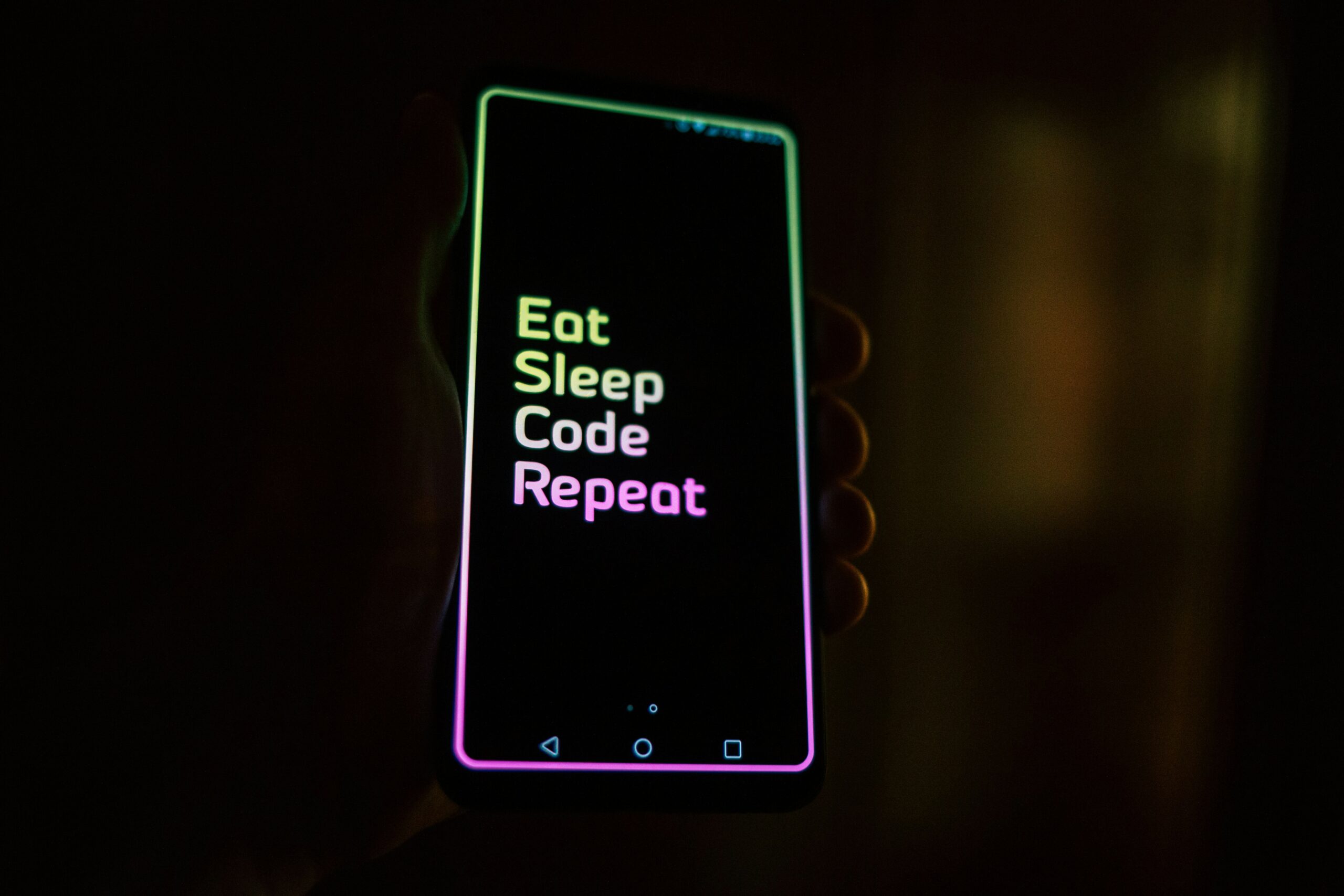 Phone screen that says "Eat, Sleep, Code, Repeat."