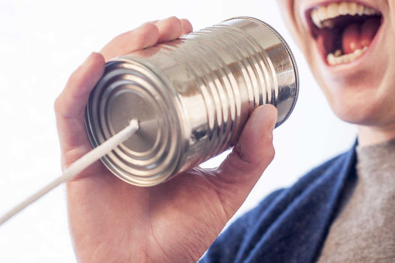 An image of a person shouting into one end of a tin can telephone. Can media really makes us better at getting the message?